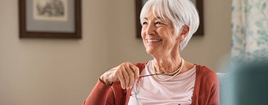 Life Assure Senior Woman Sitting In Chair And Laughing With Caregiver Nurse Hero